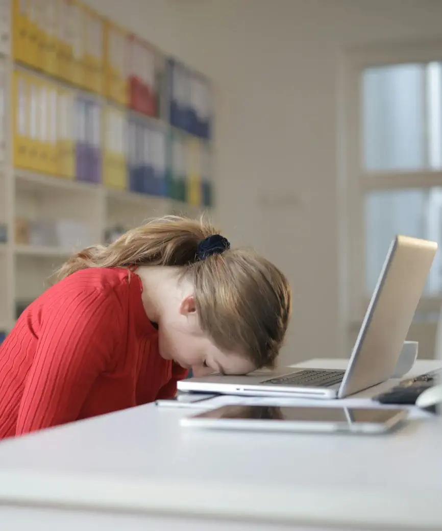 Overworked woman with head on keyboard